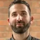 Image features a professional headshot with a neutral background, emphasizing the subject's face and upper body.