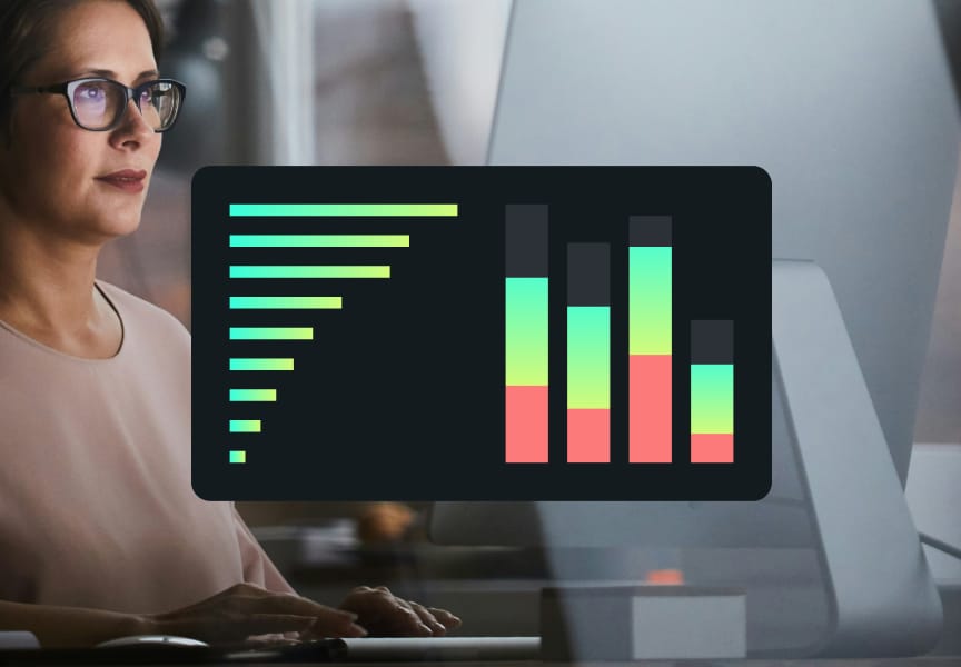 Data visualization displayed on a monitor with colorful, gradient bars and lines, used by an individual working on a computer.