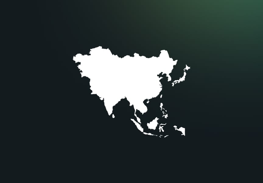 Silhouette of the Asian continent in white against a dark background, highlighting the geographical outline of Asia.