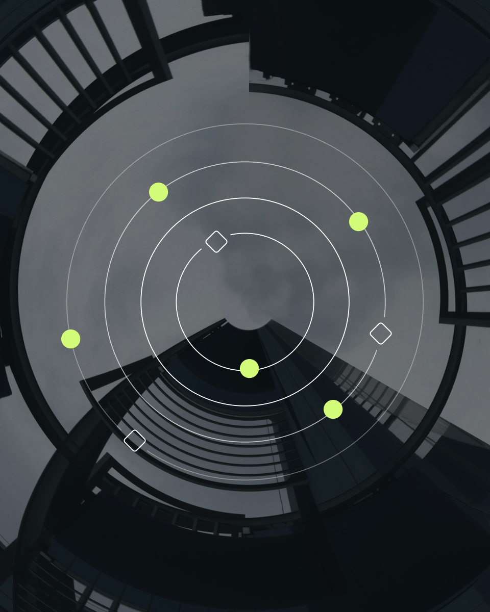 Circular abstract image featuring a spiral visual of a building with geometric elements and a grey sky backdrop.